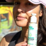 Woman posing with CBD Lotion With Aloe Vera outdoors